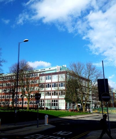A modern building with clear blue skies in an urban setting, perfect for business and cityscape themes.